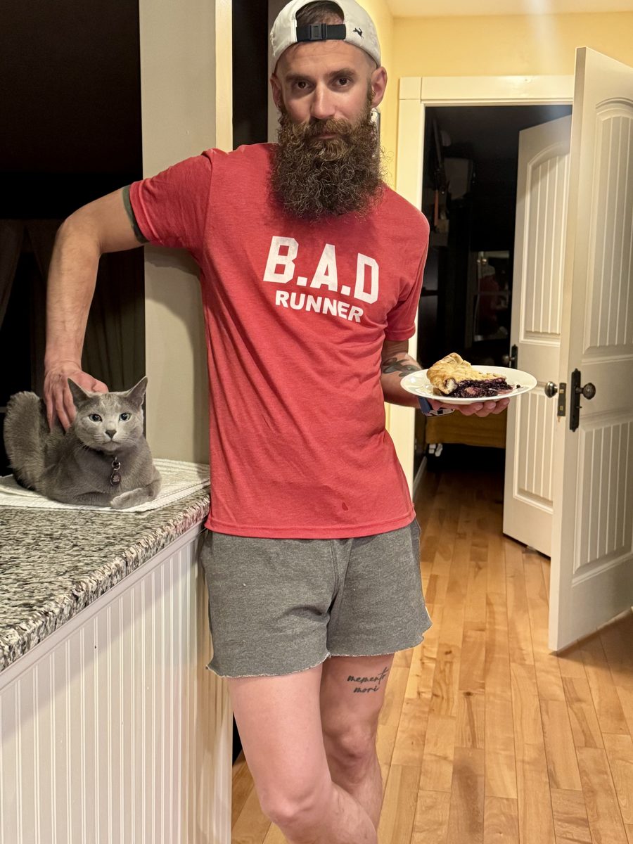 Athlete in a red B.A.D Runner tee with a gray cat